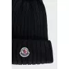 Black hat with a pompom