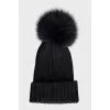 Black hat with a pompom