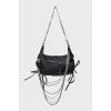 Leather bag decorated with chains and crystals