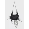 Leather bag decorated with chains and crystals