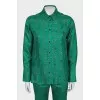 Suit with a silk blouse with a tag