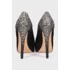 Black suede shoes decorated with rhinestones