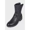 Black leather boots with a zipper