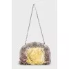 The textile bag is decorated with flowers