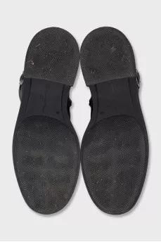 Black leather boots with straps