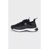 Black sneakers with a gold logo