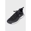 Black sneakers with a gold logo