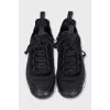 Black sneakers with a gold logo
