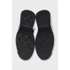 Black sneakers with a gold logo