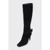 Black suede boots with a bow