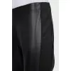 Black eco-leather trousers with stripes