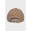 Men's textile cap with a signature print