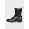 Black boots decorated with straps