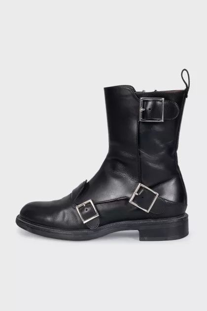 Black boots decorated with straps