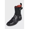 Black boots decorated with straps