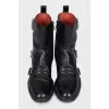 Black boots decorated with straps