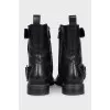 Black boots decorated with straps