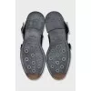 Black boots decorated with straps