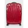 Red suitcase with a relief pattern