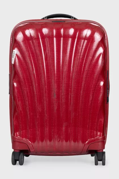 Red suitcase with a relief pattern