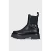 Black leather boots with a silver buckle