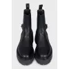 Black leather boots with a silver buckle
