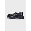 Black loafers with gold decor