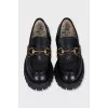 Black loafers with gold decor