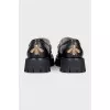 Black loafers with gold decor
