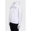 White zip-up hoodie with silver logo