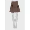 High-waisted pleated shorts
