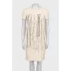 Fitted dress with decorative elements on the front