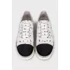 White textile sneakers with a contrasting toe