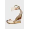 Snakeskin sandals with a gold wedge heel
