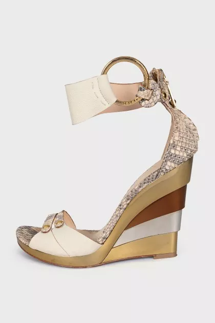 Snakeskin sandals with a gold wedge heel