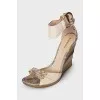 Snakeskin sandals with a gold wedge heel