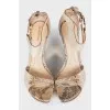 Snakeskin sandals with a gold wedge heel