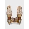 Snakeskin sandals with a gold wedge heel