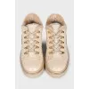Insulated leather boots with gold-tone hardware