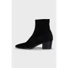 Black suede ankle boots with a stacked heel
