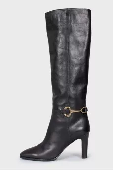 Black leather boots with a gold buckle