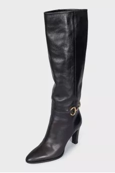 Black leather boots with a gold buckle