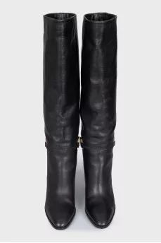 Black leather boots with a gold buckle