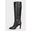 Black leather boots with gold trim