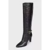 Black leather boots with gold trim