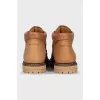 Leather boots with a logo on the back