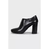 Black leather ankle boots with a zipper