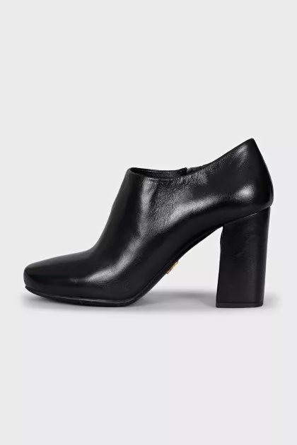 Black leather ankle boots with a zipper