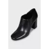 Black leather ankle boots with a zipper