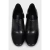 Black leather ankle boots with a zipper